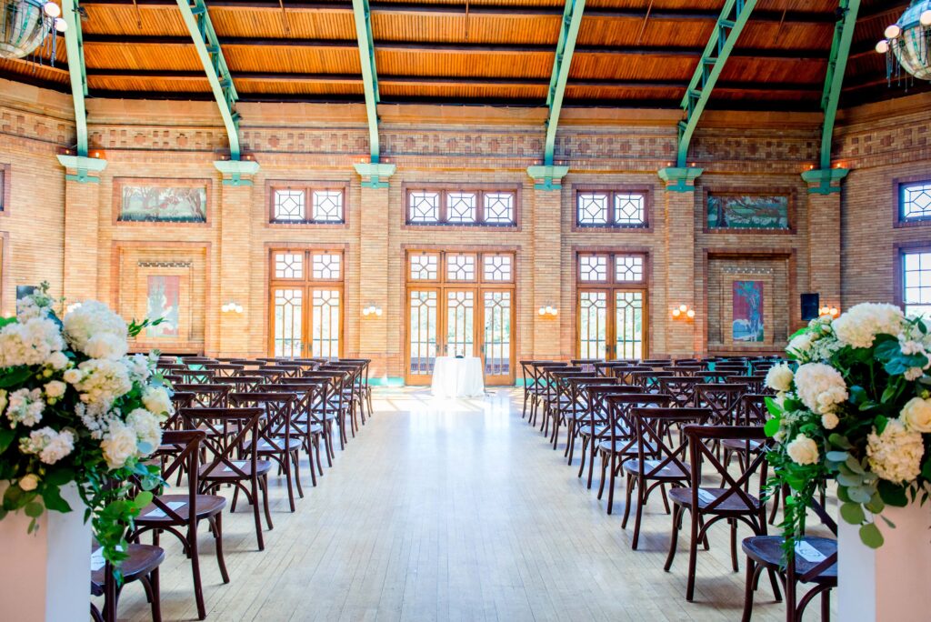 ceremony set up with chairs and white florals at Cafe Brauer 