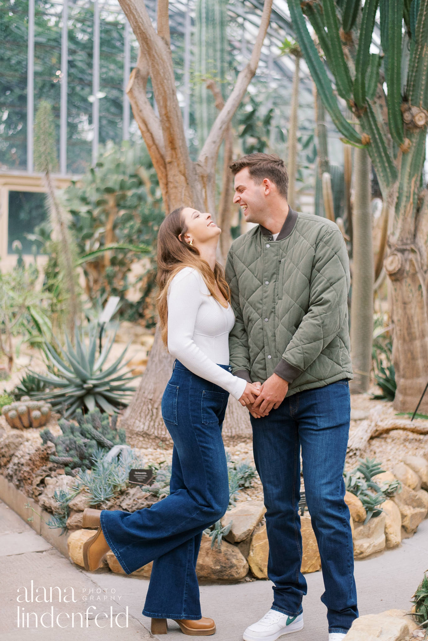 smiling couple at Garfield Park Conservatory desert room after proposal