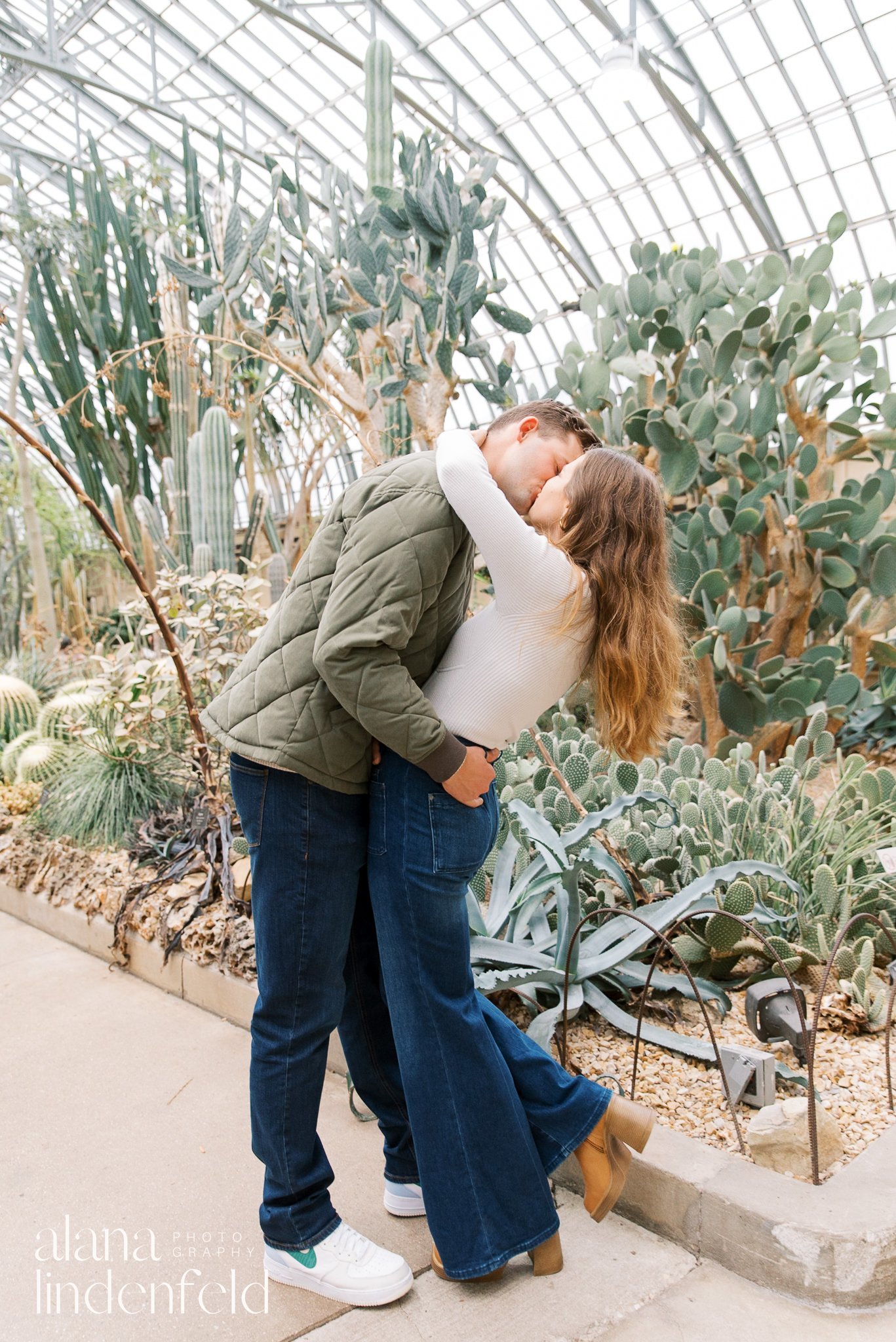 kissing couple at Garfield Park Conservatory desert room after winter proposal