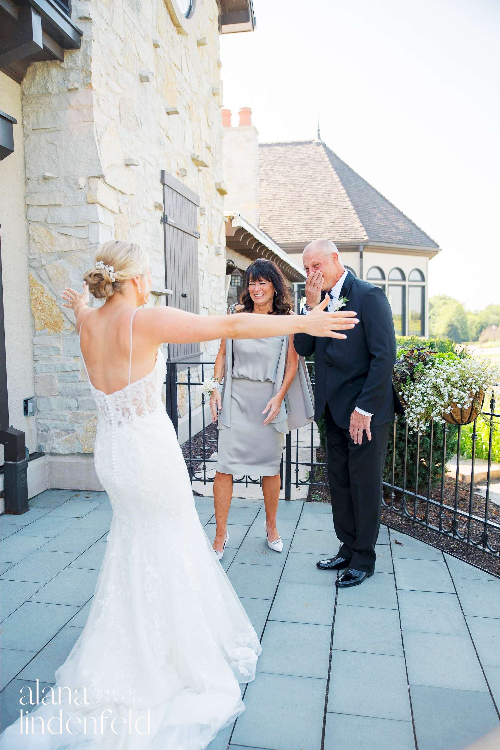 bride has first look with emotional parents at Mistwood Golf Club
