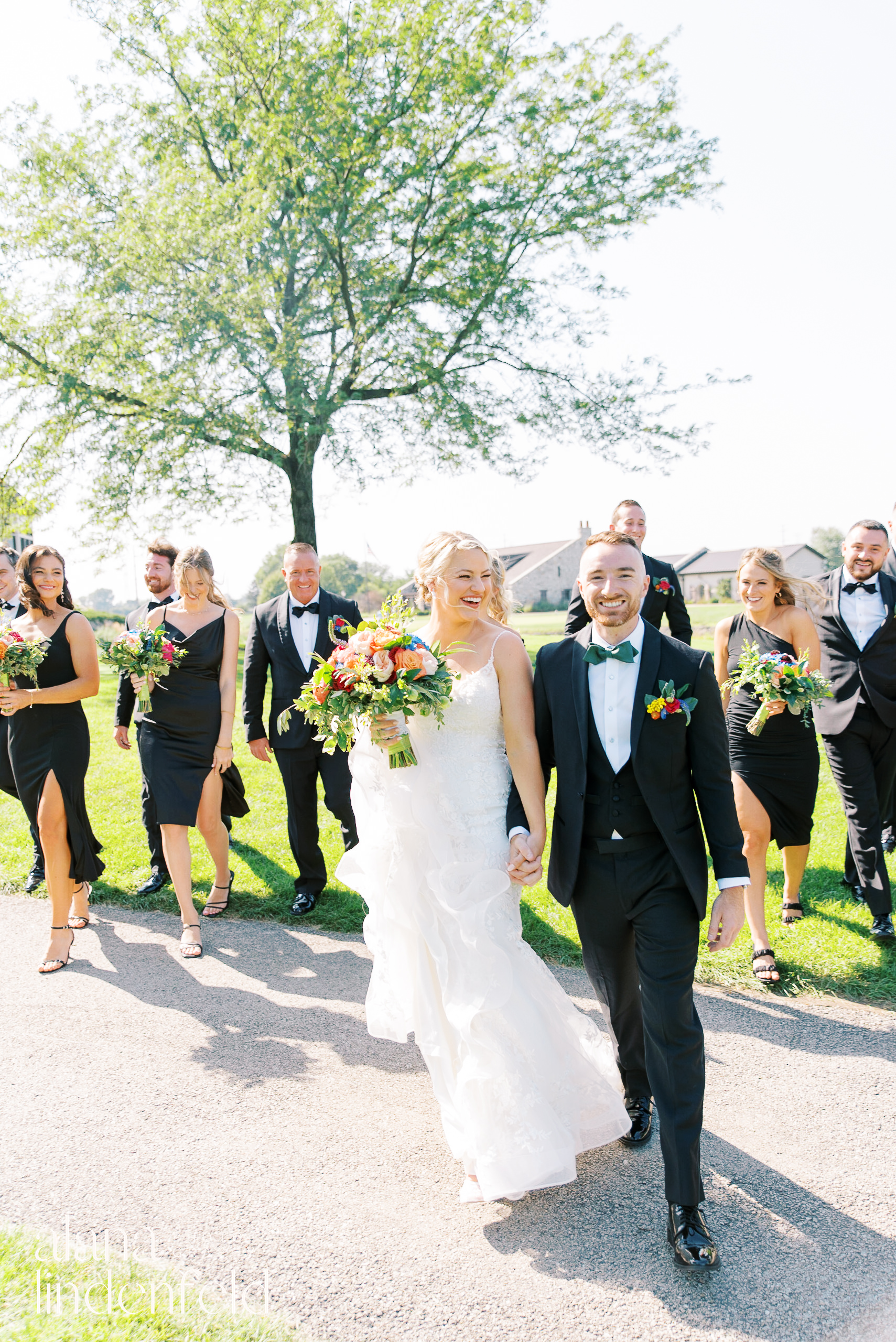 bridal party in all black with colorful flowers at Mistwood Golf Club summer wedding