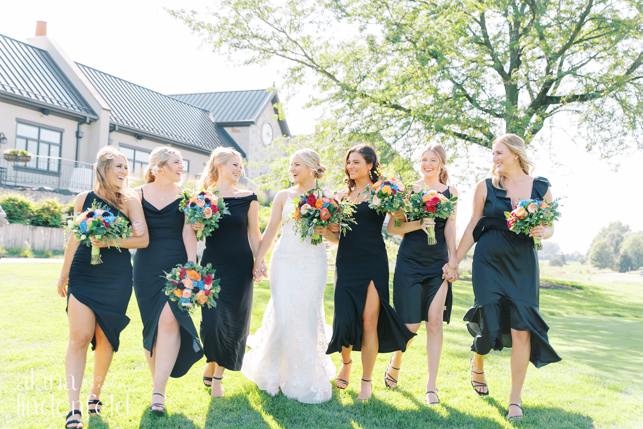bridesmaids in black dresses and colorful flowers at summer wedding at Mistwood Golf Club