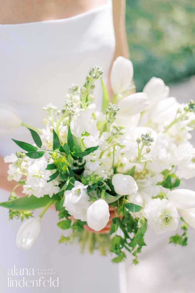 bride holding bouquet of white tulips 