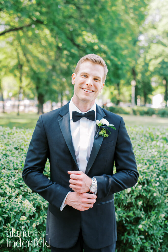 groom in black tux smiling in Millennium Park Chicago