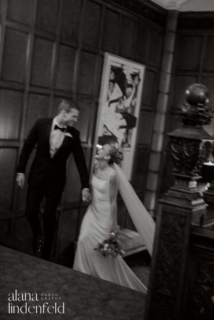 laughing bride and groom on stairs at university club of chicago
