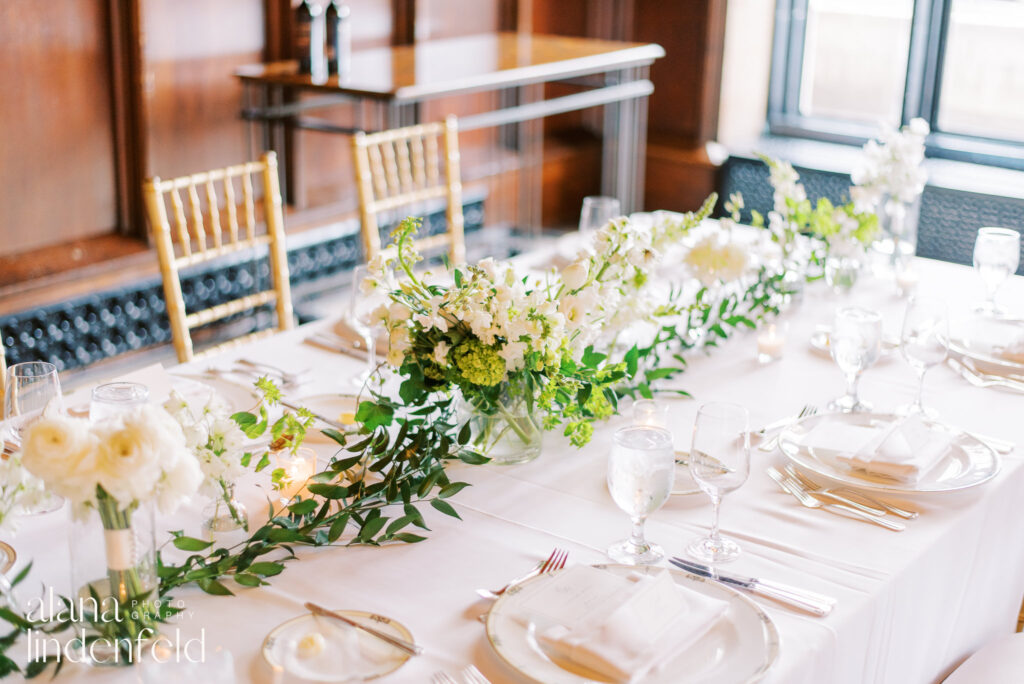 modern white and green florals on wedding dinner table