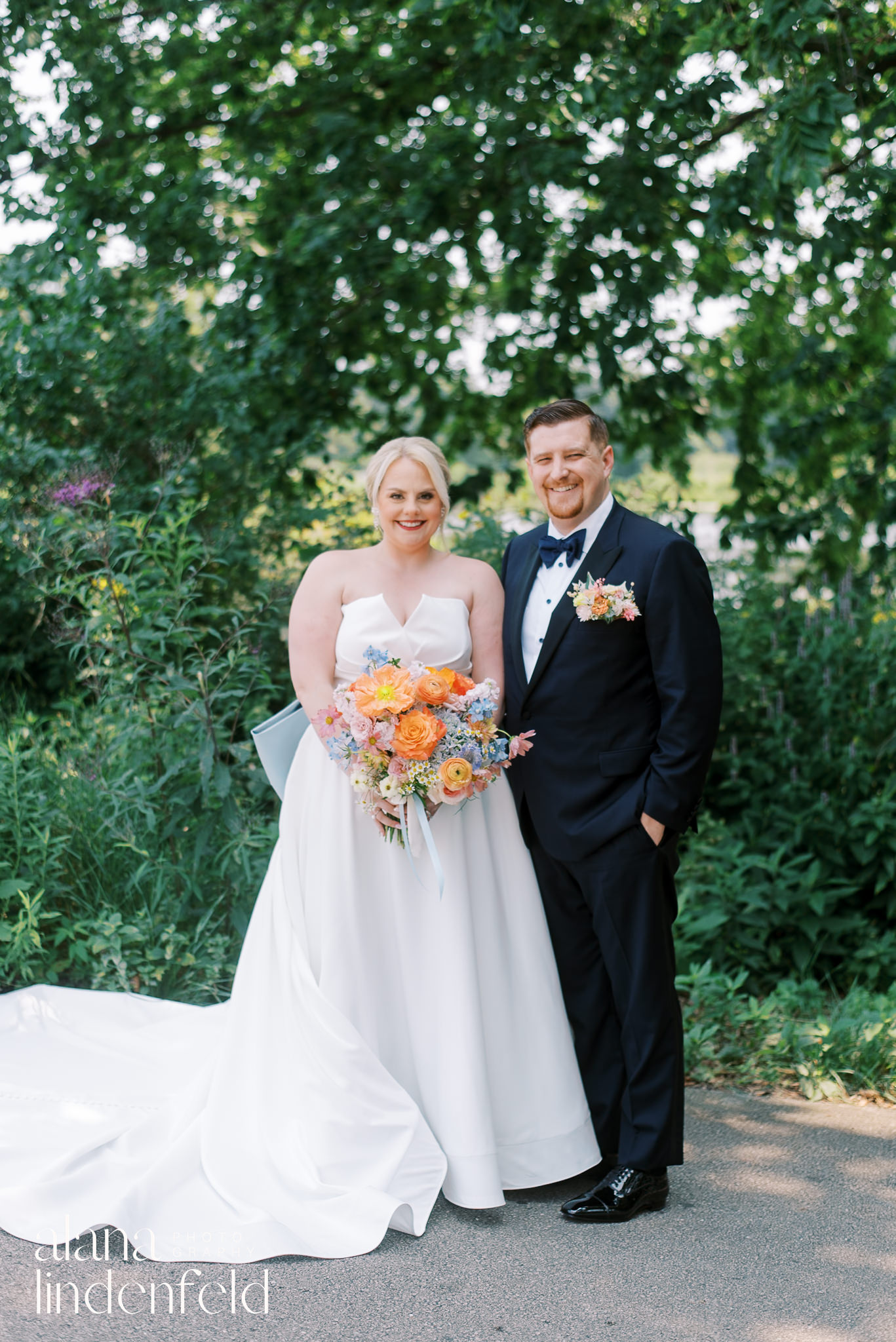 bride and groom in front of south pond lincoln park on wedding day
