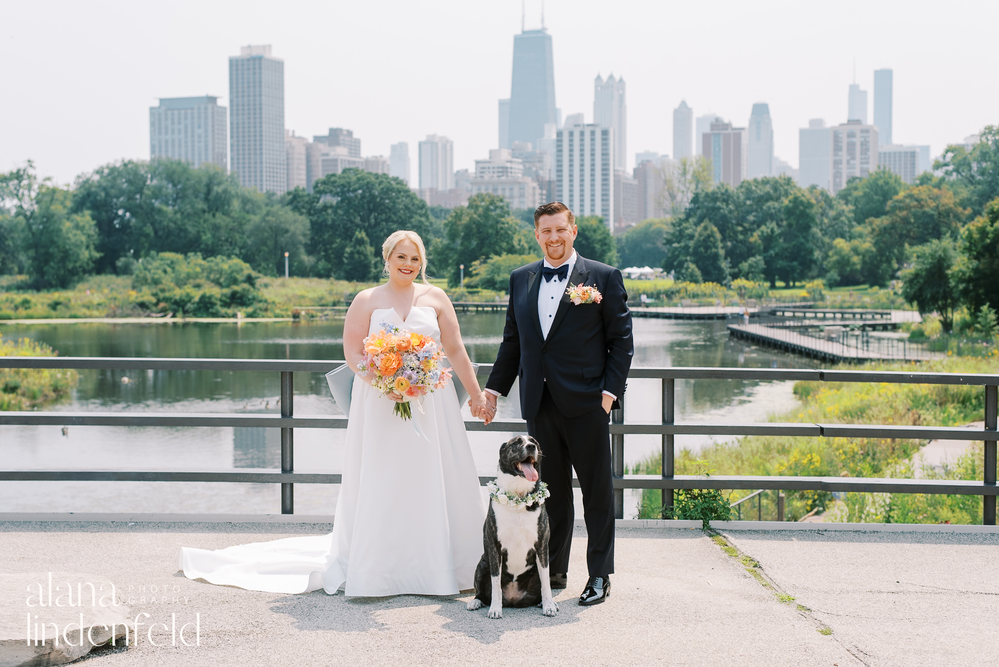 bride and groom with their dog on South pond bridge in Lincoln Park Chicago