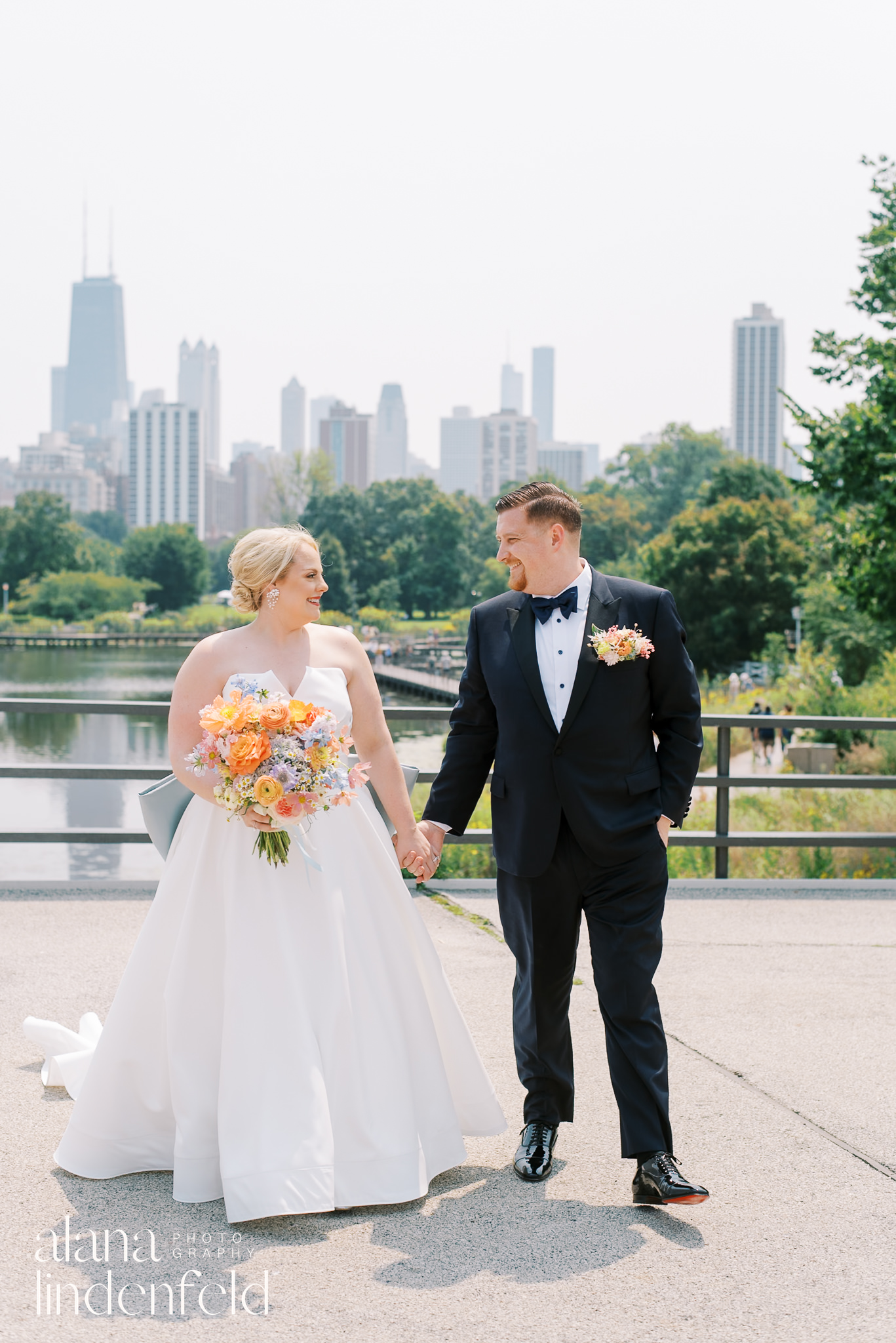 bride and groom in front of south pond lincoln park on wedding day
