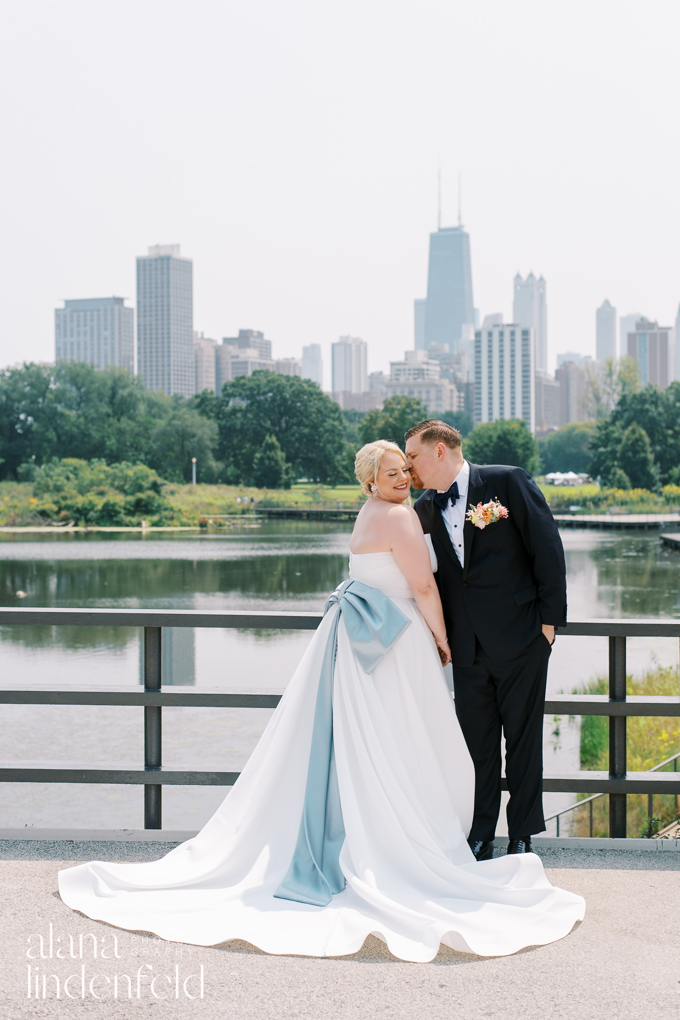 bride and groom in front of south pond lincoln park on wedding day
