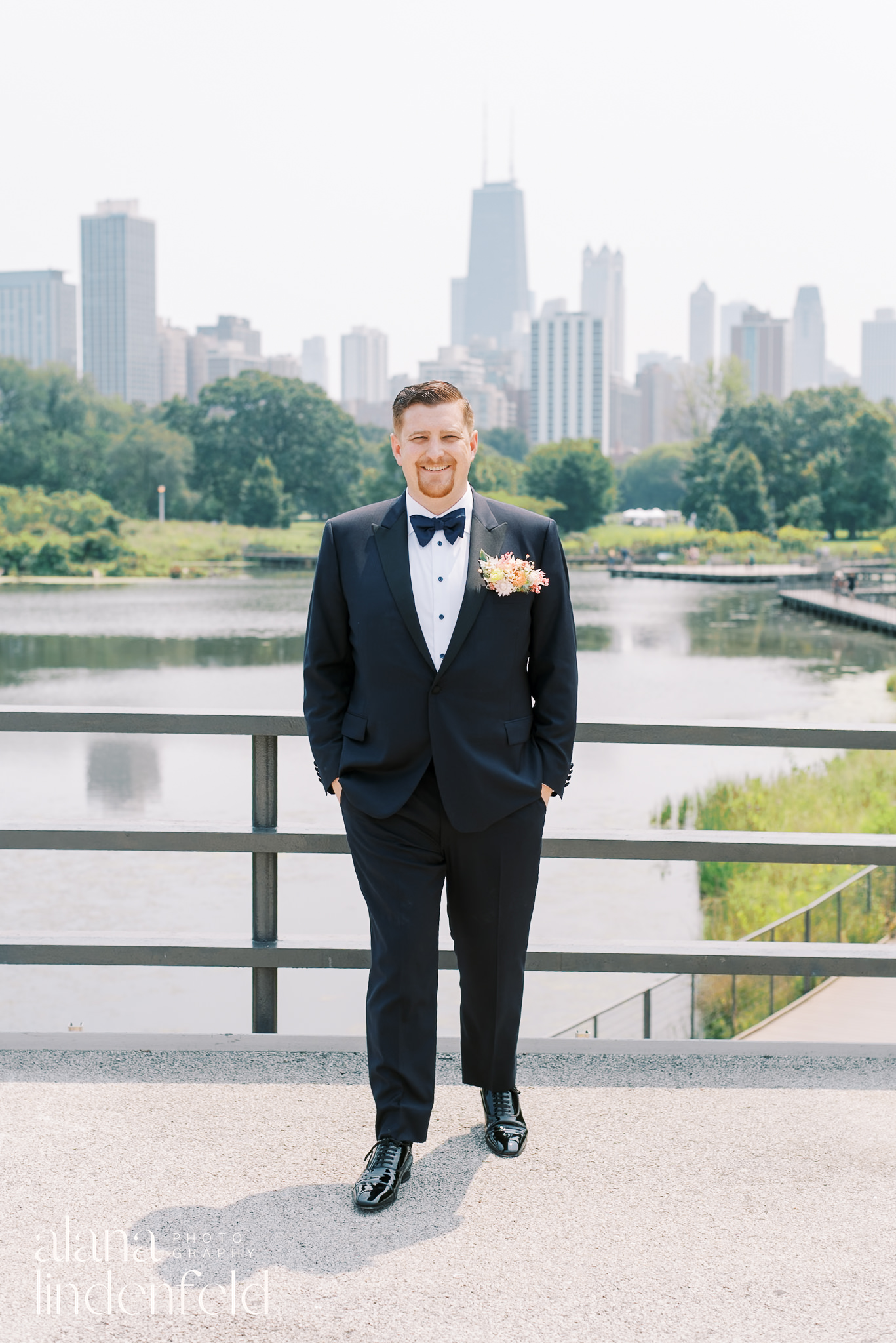 groom in front of south pond lincoln park on wedding day
