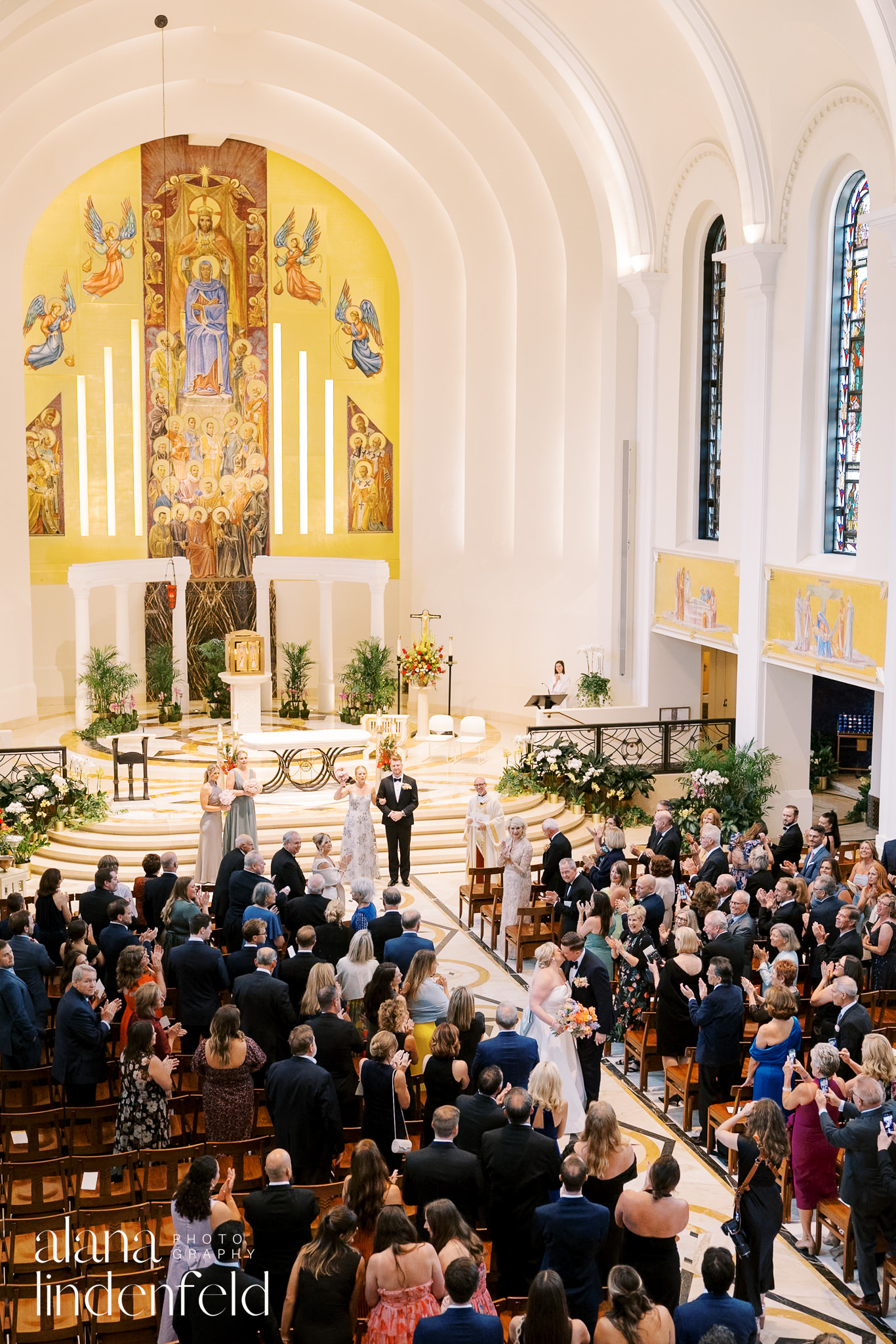 bride and groom kiss in church aisle at madonna della strada church