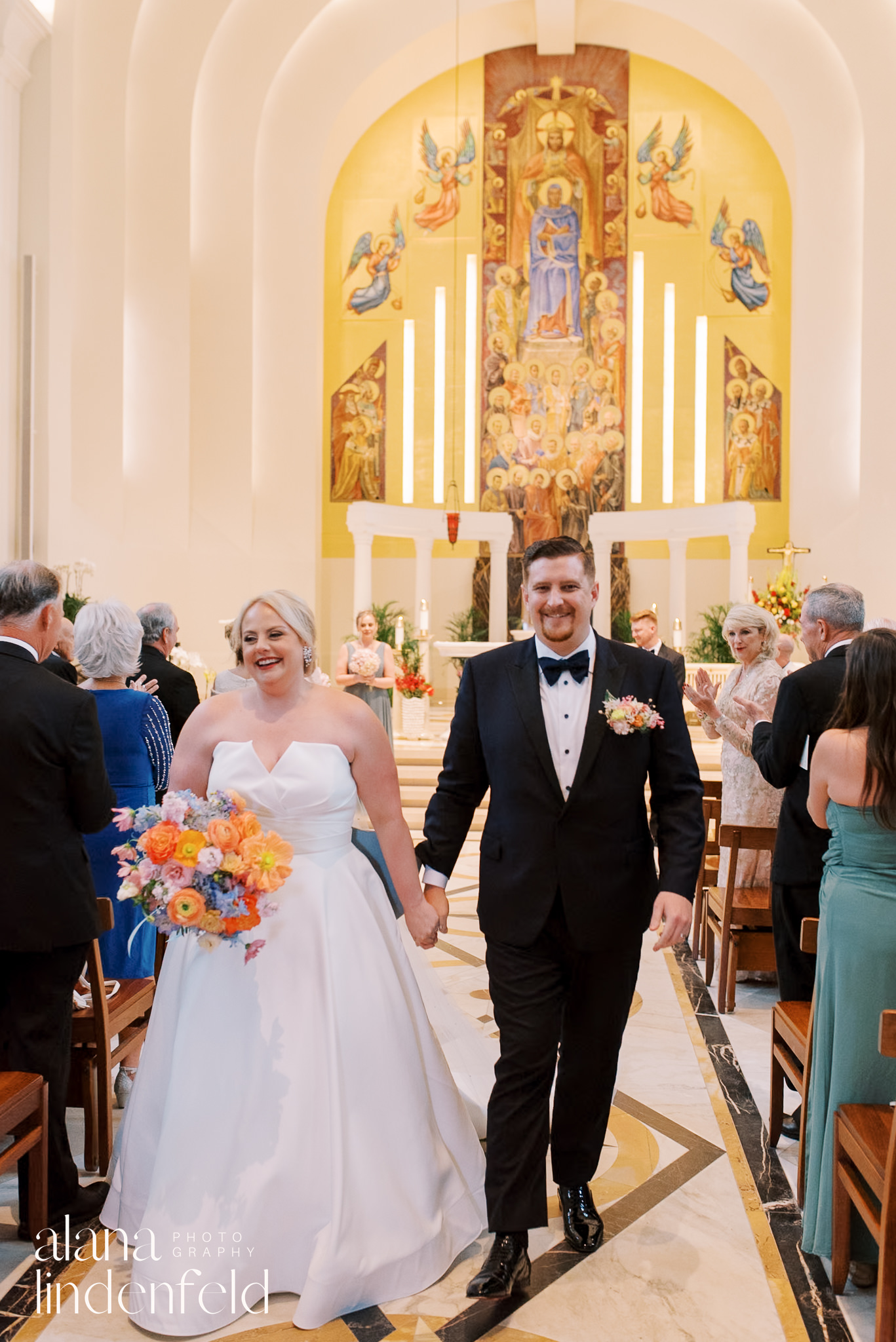 bride and groom walk down aisle at madonna della strada church