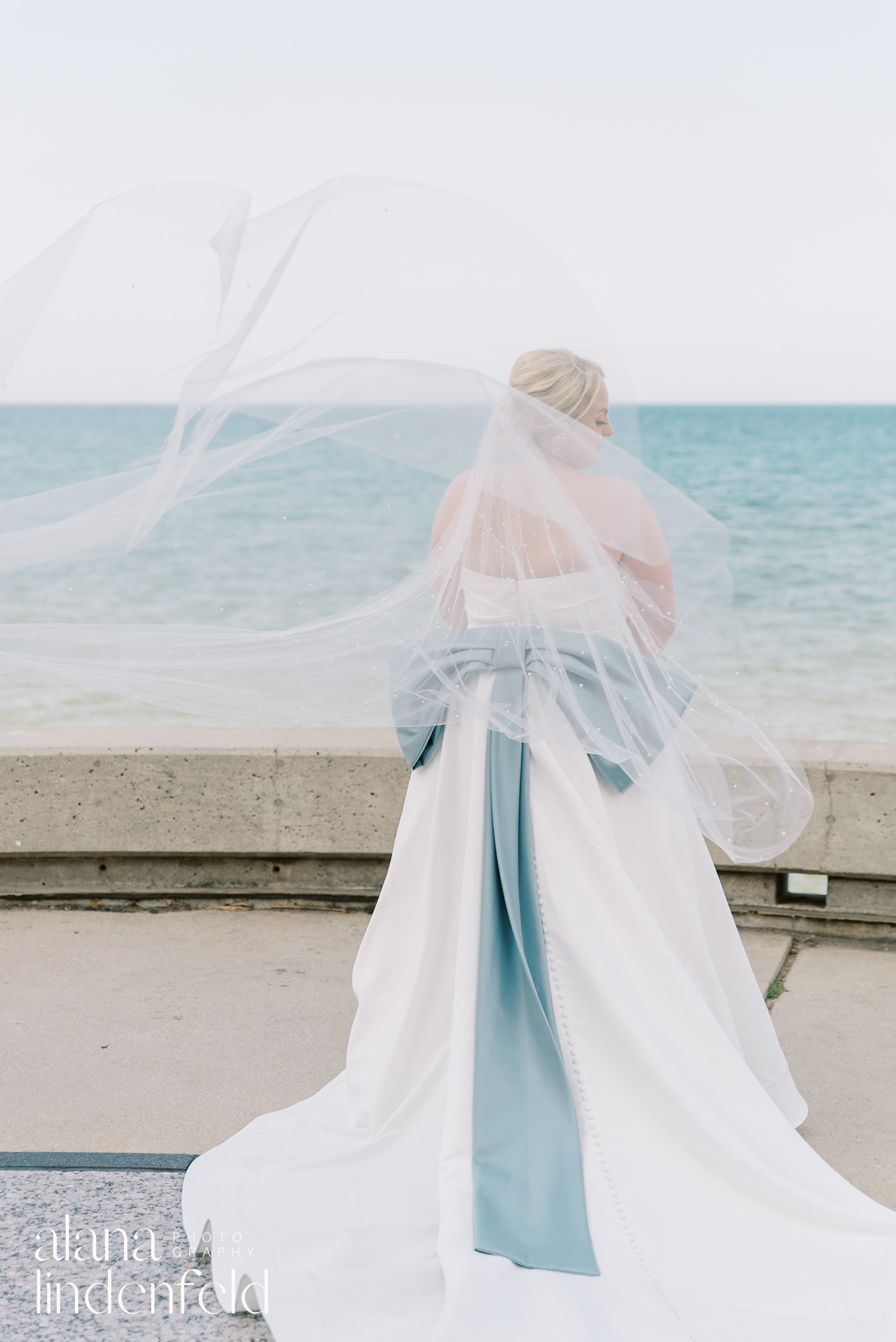 bride with blue bow dress at lake michigan chicago wedding