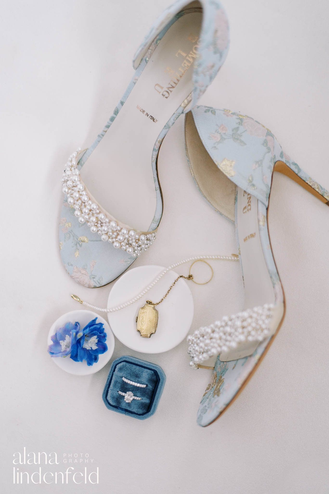 blue wedding shoes flat lay with velvet ring box