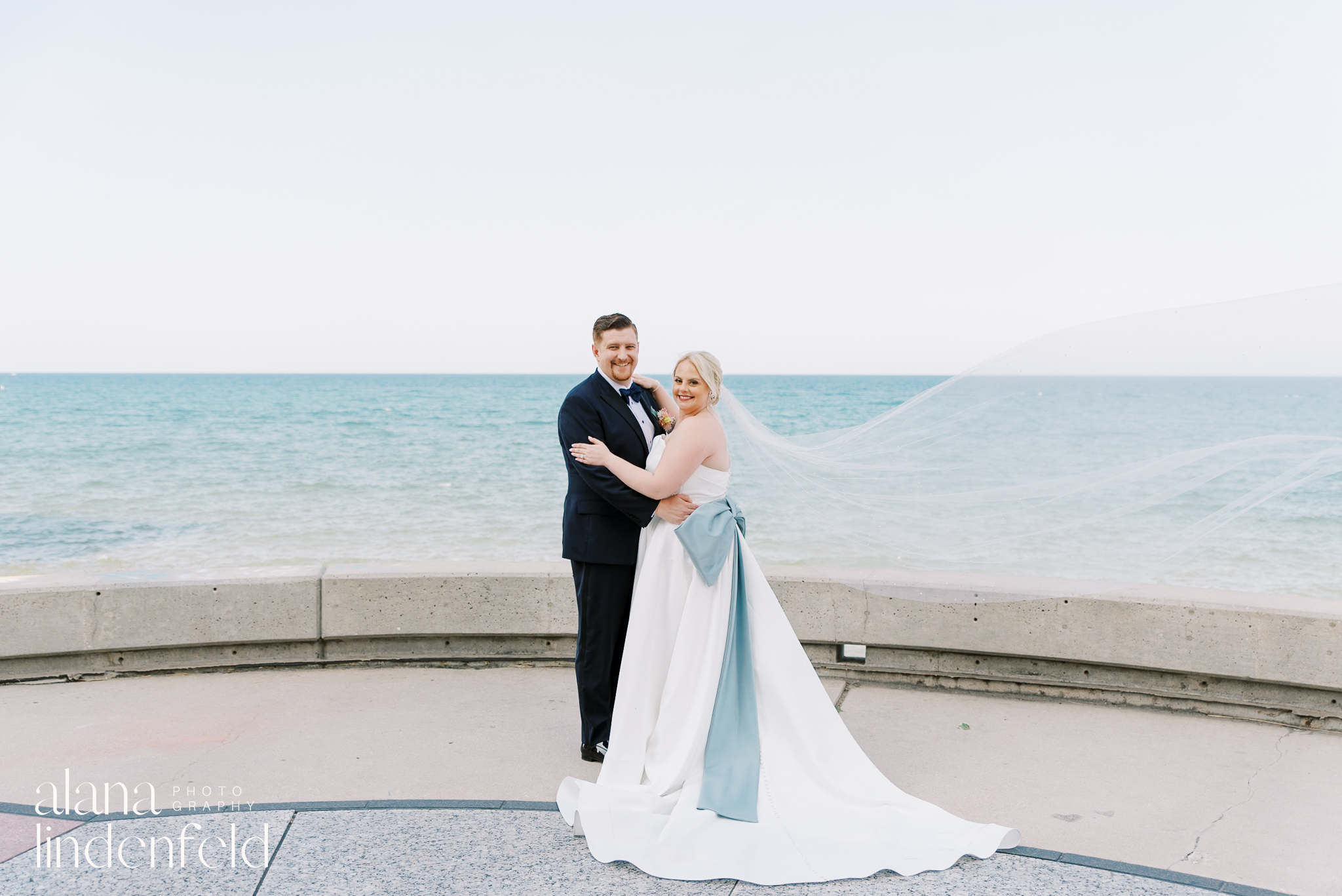 bride and groom lakeside wedding portraits at loyola university