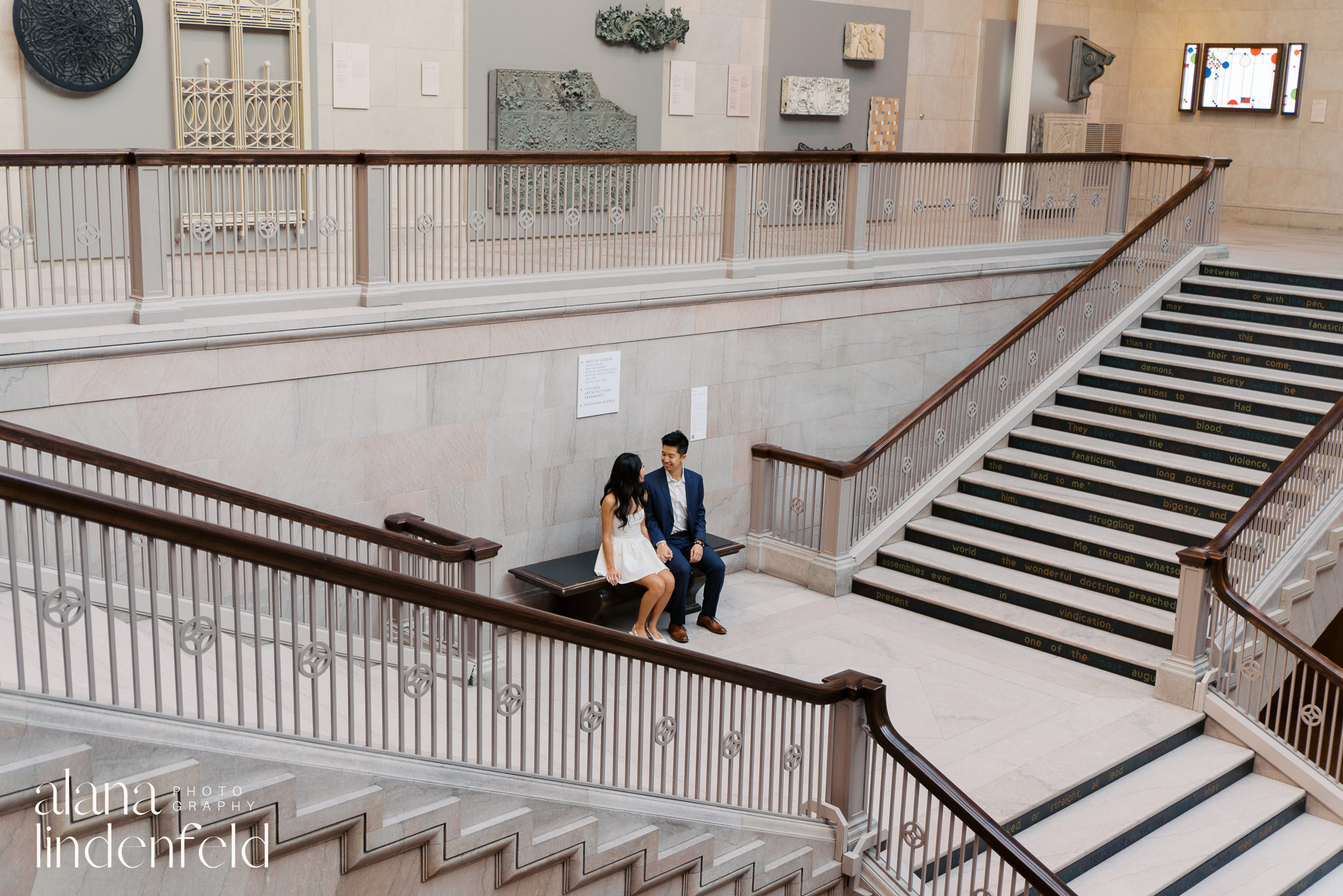 couple sitting at Chicago Art Institute Womans Grand Board Staircase