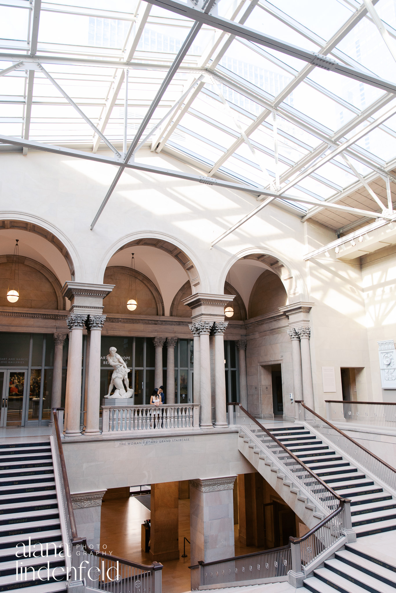 Asian couple standing in Womans Board Grand Staircase at Art Institute of Chicago 