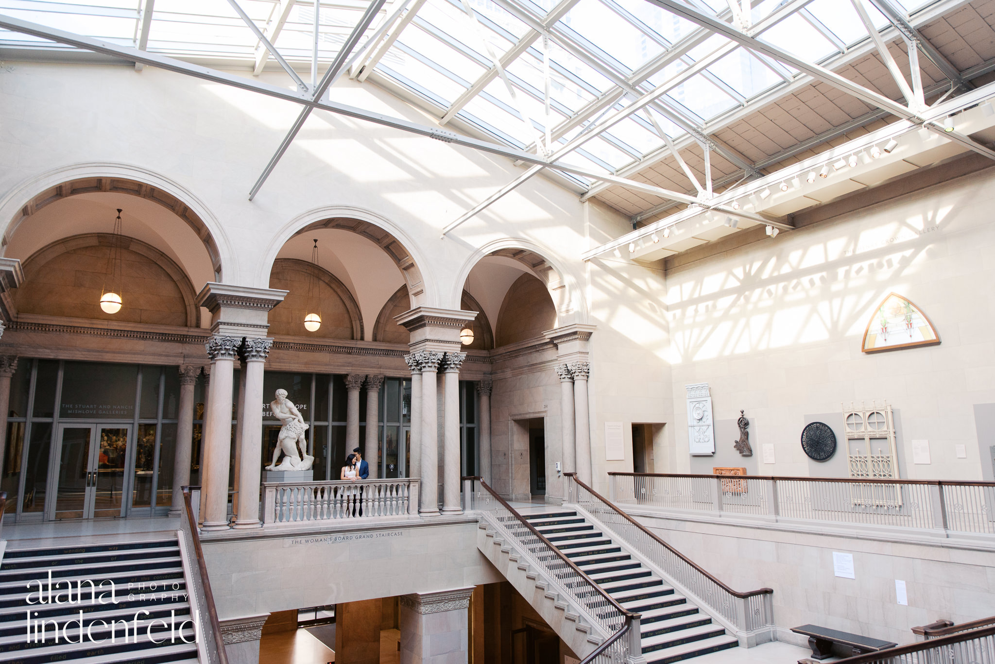 Asian couple standing in Womans Board Grand Staircase at Art Institute of Chicago 