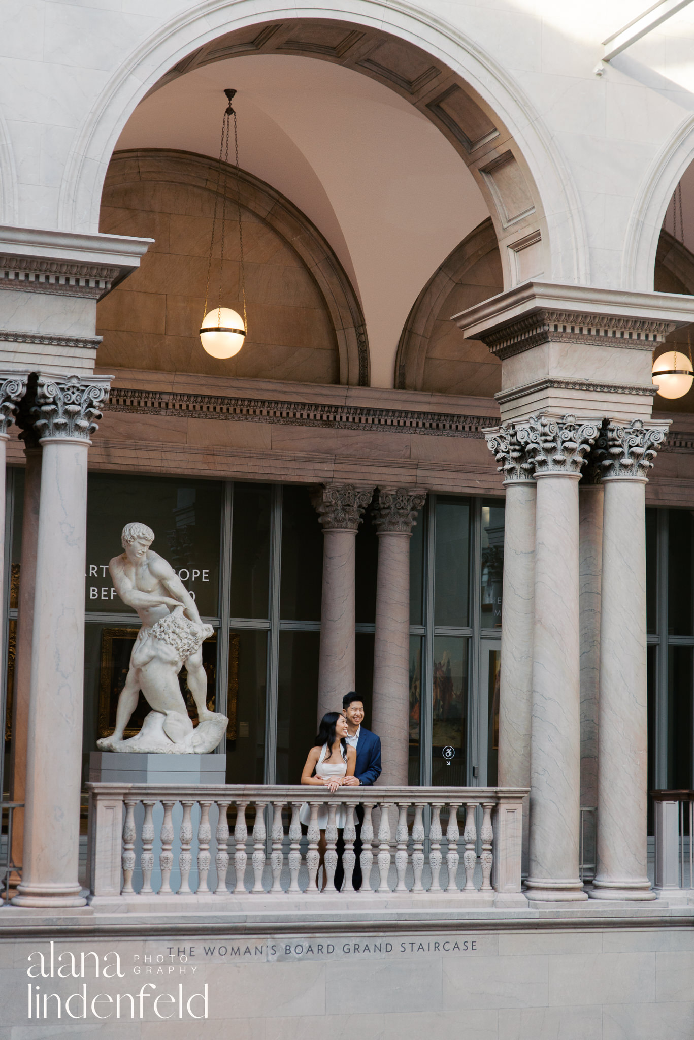 Asian couple standing in Womans Board Grand Staircase at Art Institute of Chicago 