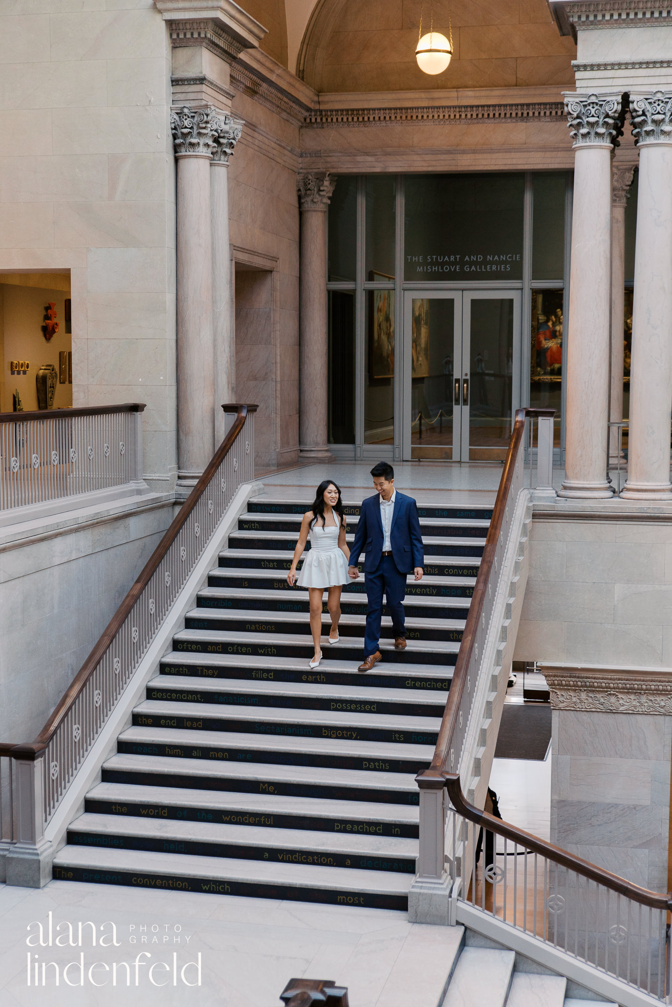 Asian couple standing in Womans Board Grand Staircase at Art Institute of Chicago 