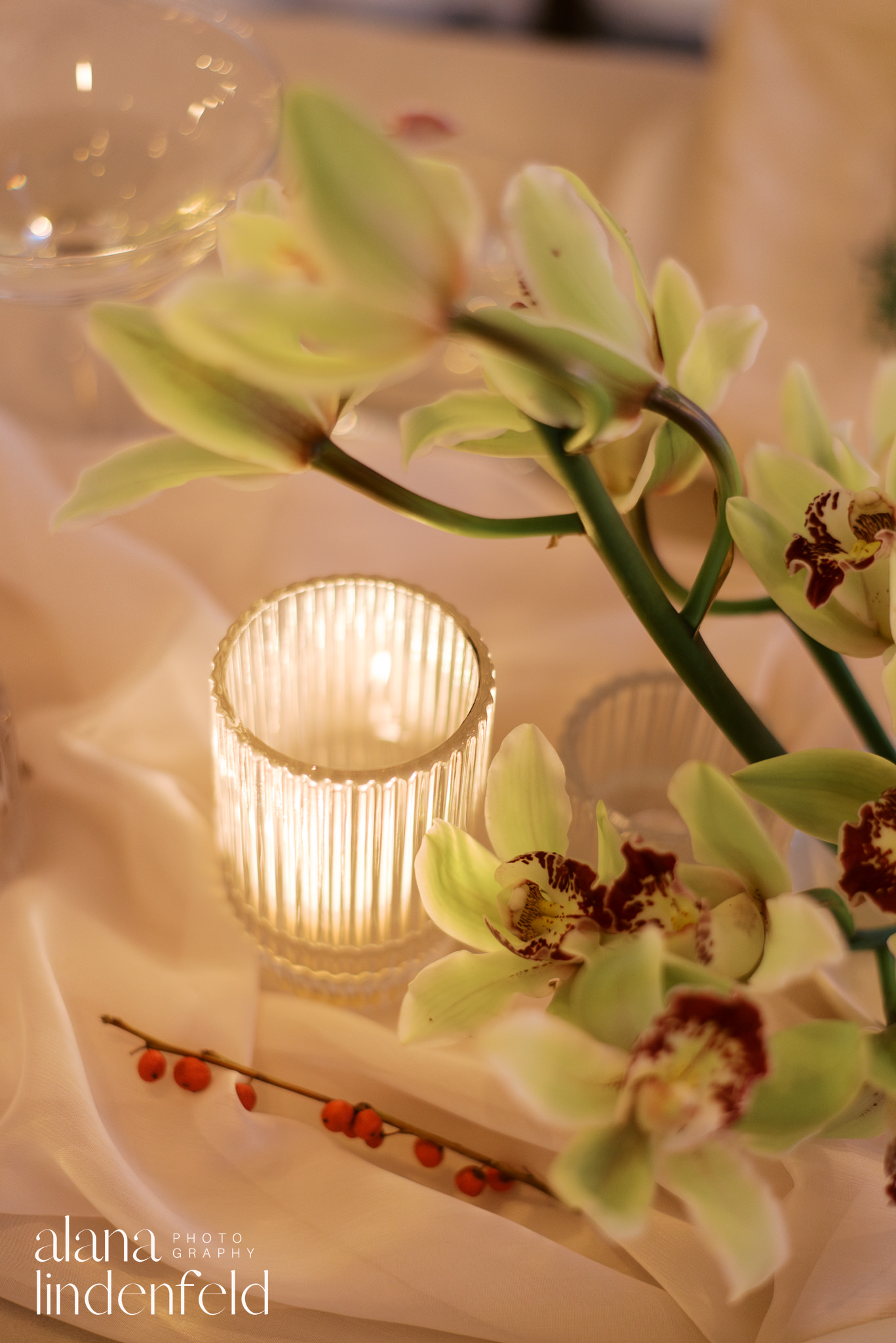 green orchids and candles at room 1520 winter reception