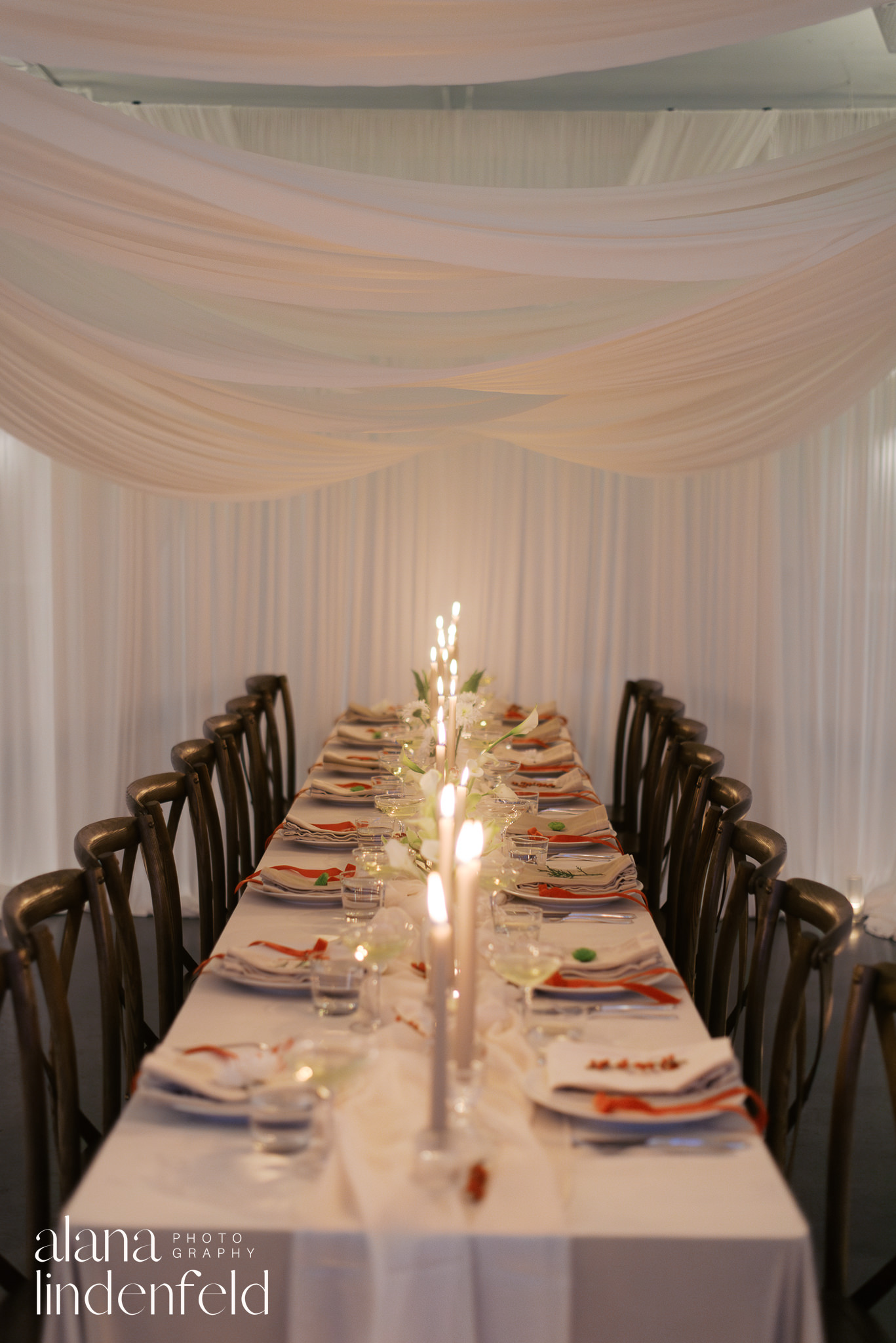 candlelit draped dinner reception at room 1520 with red and green flowers