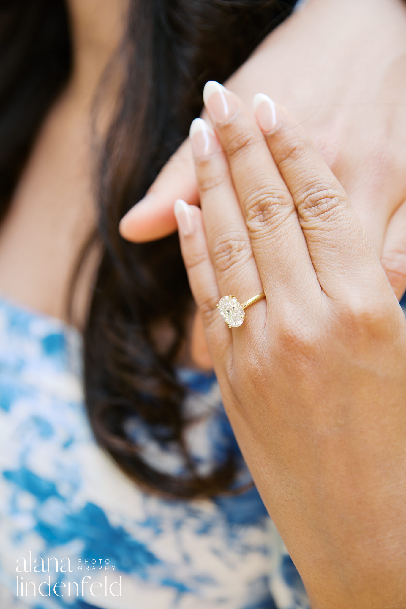 oval diamond engagement ring on hand