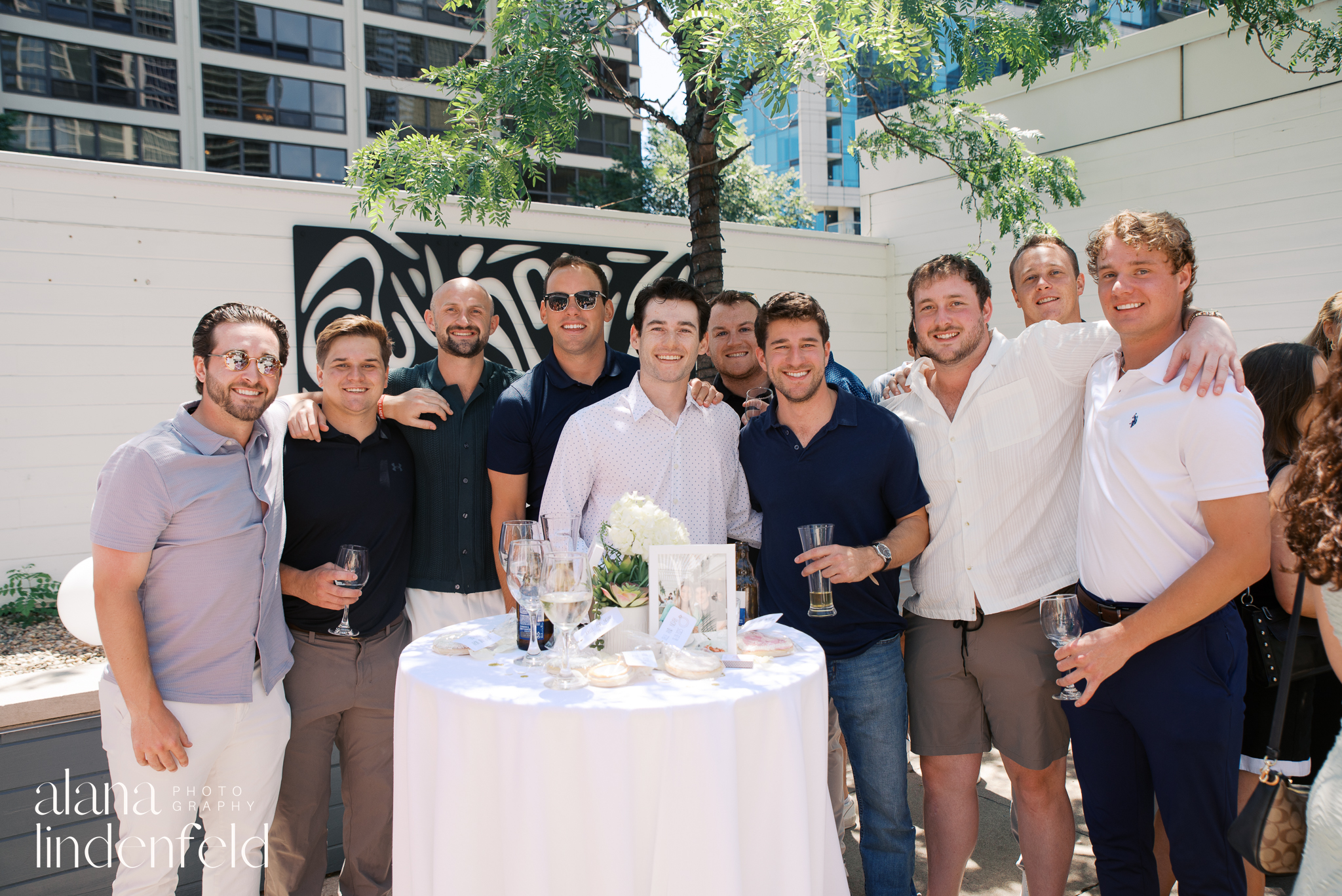 group of men smiling after proposal at Avli on the Park