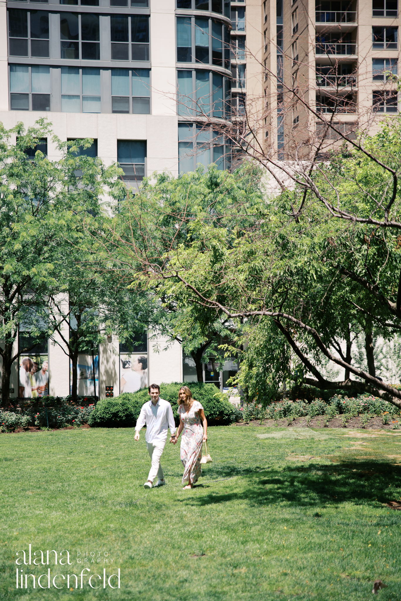 couple in formal summer clothes walking into Lakeshore East Park