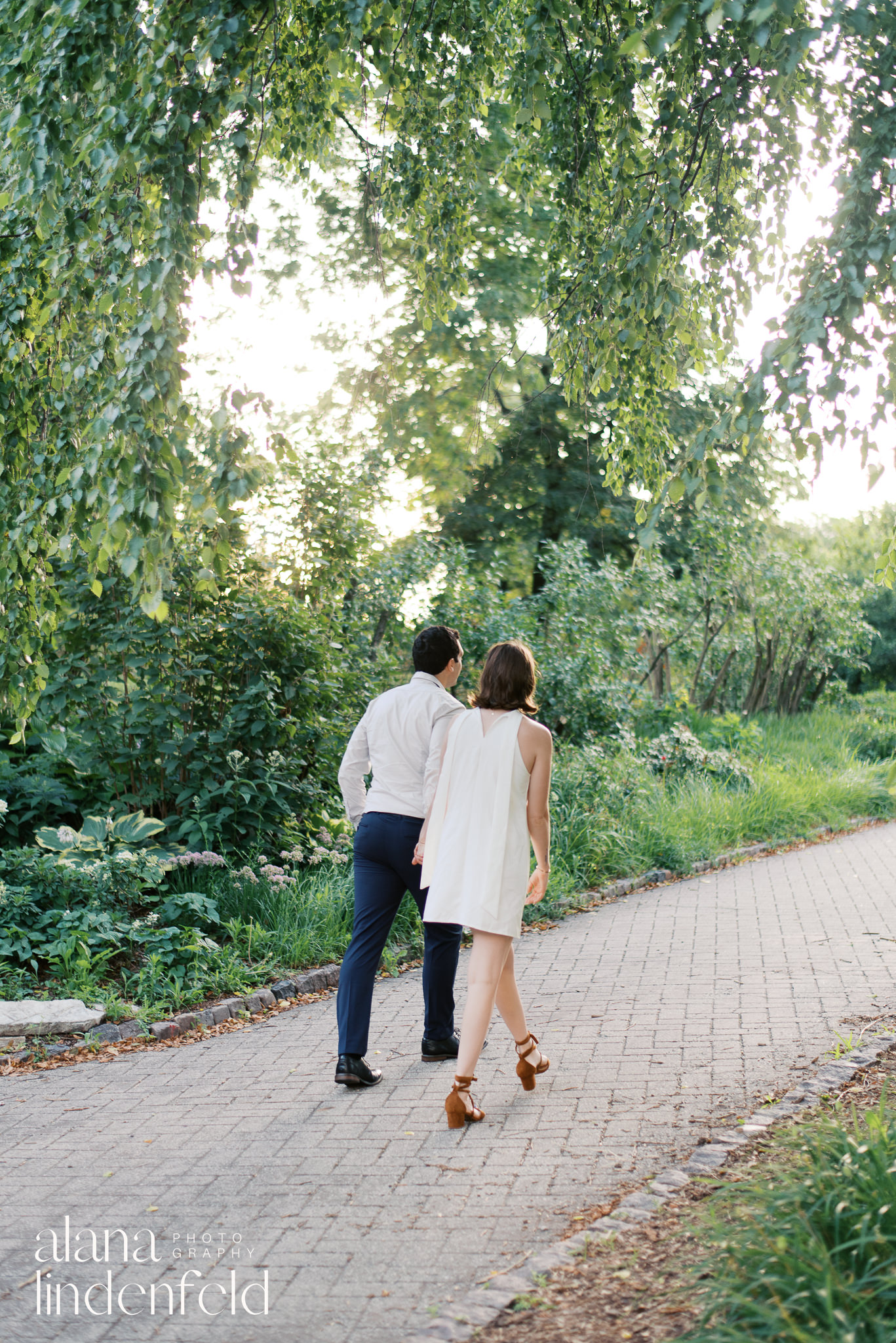 couple walking away through the park at North Pond chicago engagement pictures