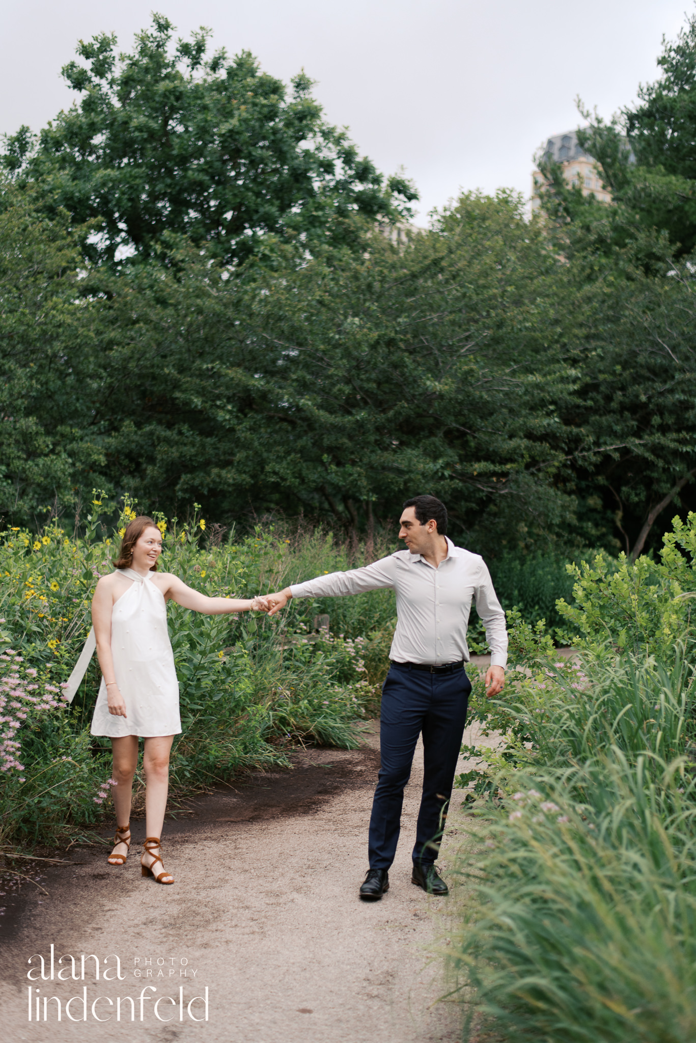 couple in formal wear walking through Peggy Notebart Nature center for engagement photos