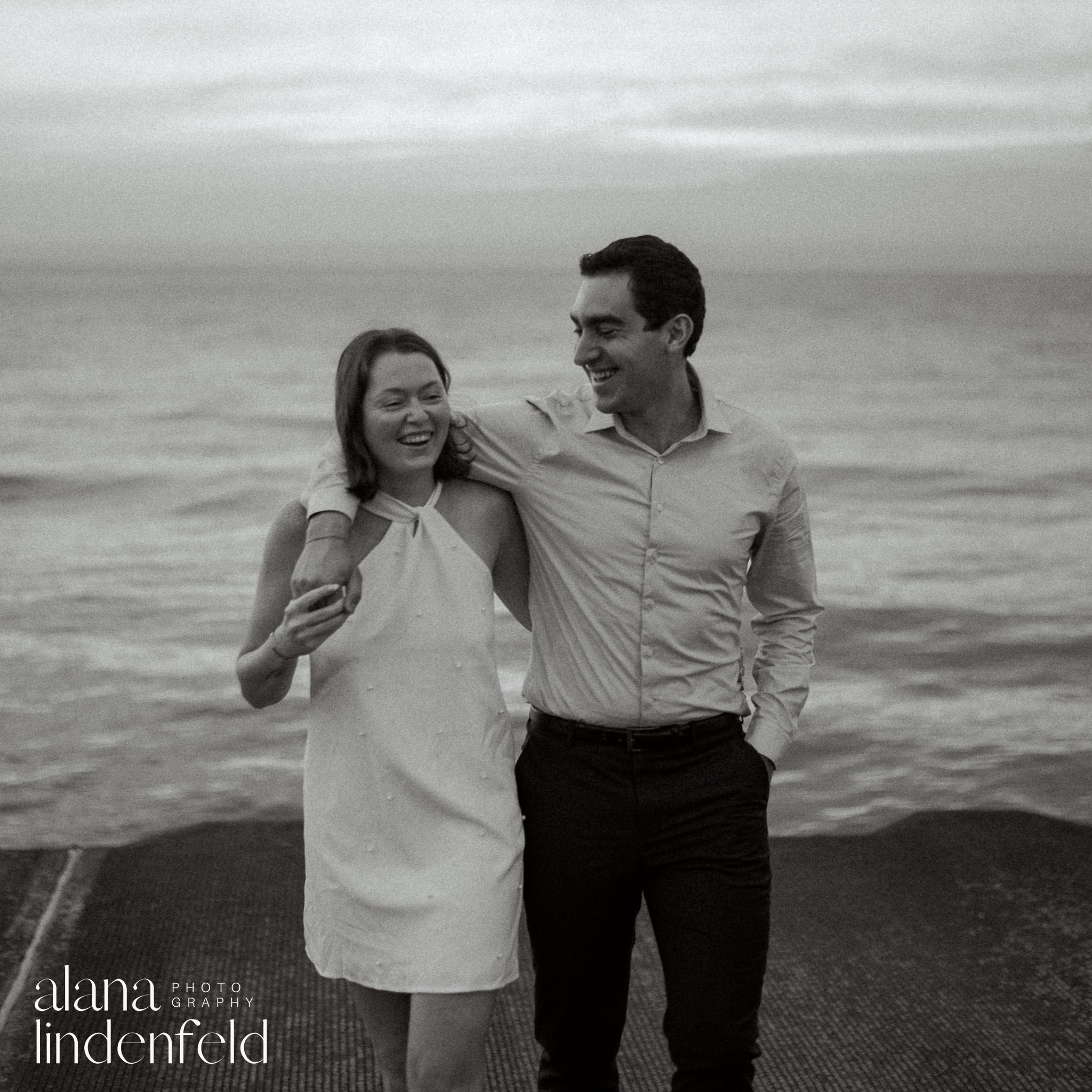 black and white photo of couple at Lake Michigan sunrise engagement 