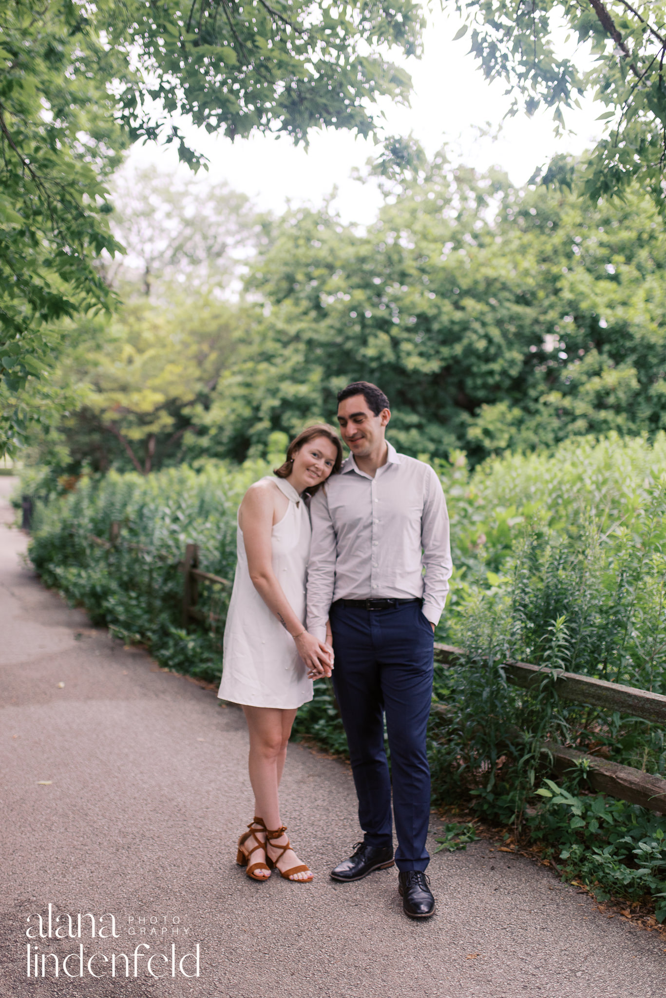 couple in formal wear walking through Peggy Notebart Nature center for engagement photos