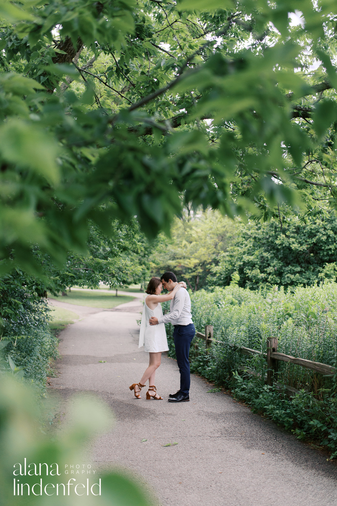 couple in formal wear walking through Peggy Notebart Nature center for engagement photos