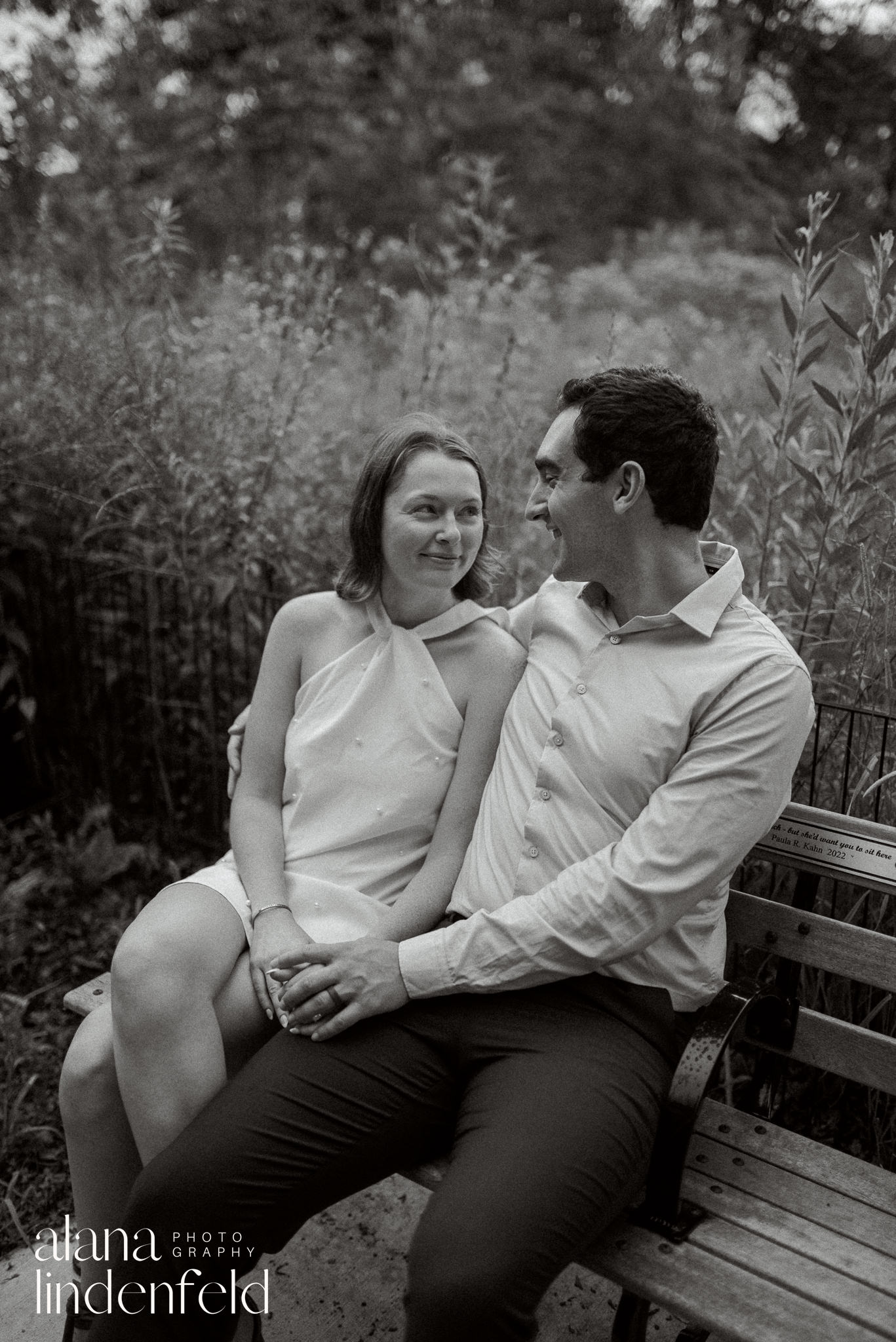 couple on a bench at North Pond in Lincoln Park for engagement pictures in black and white