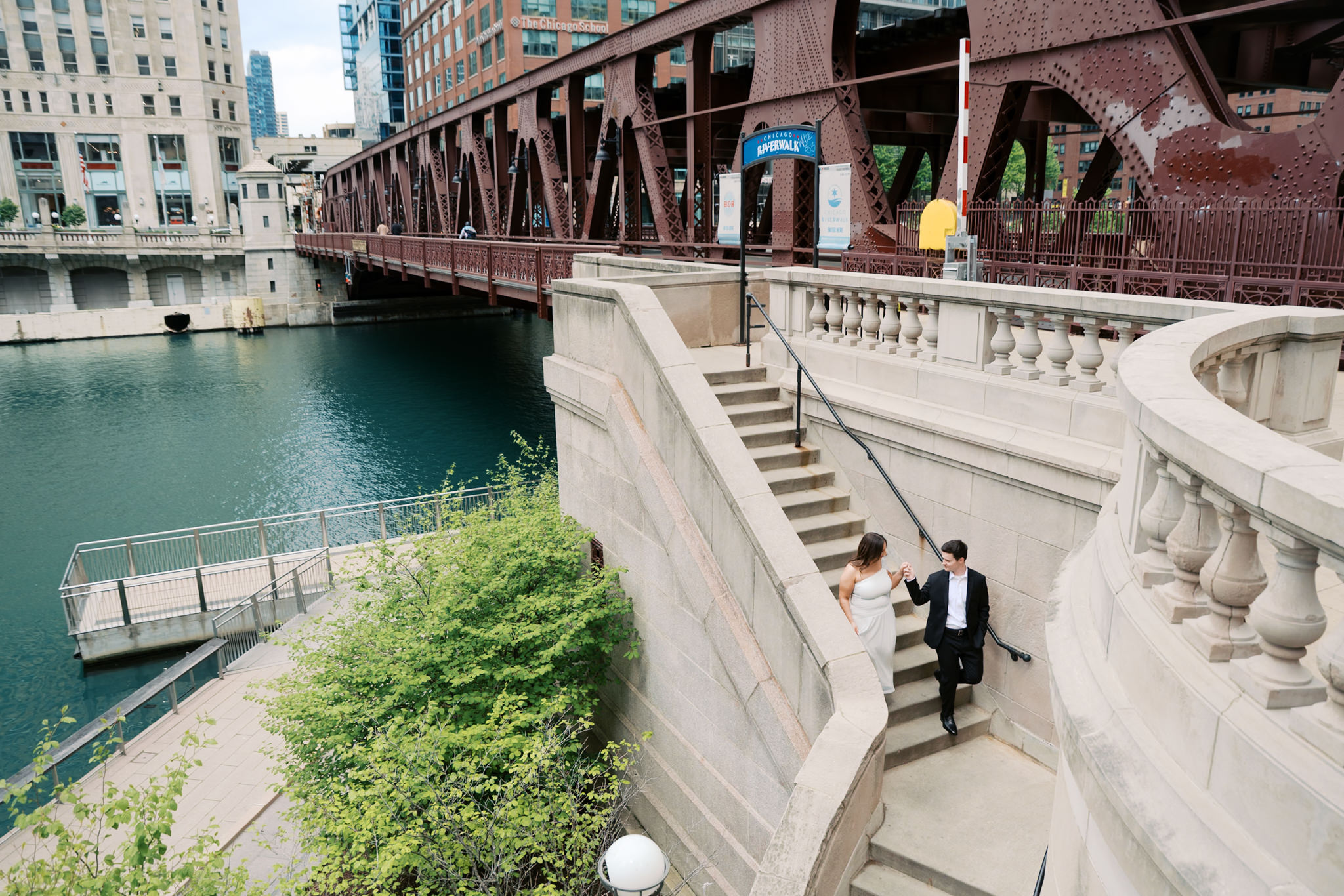 couple on stairs of Chicago Riverwalk engagement picture