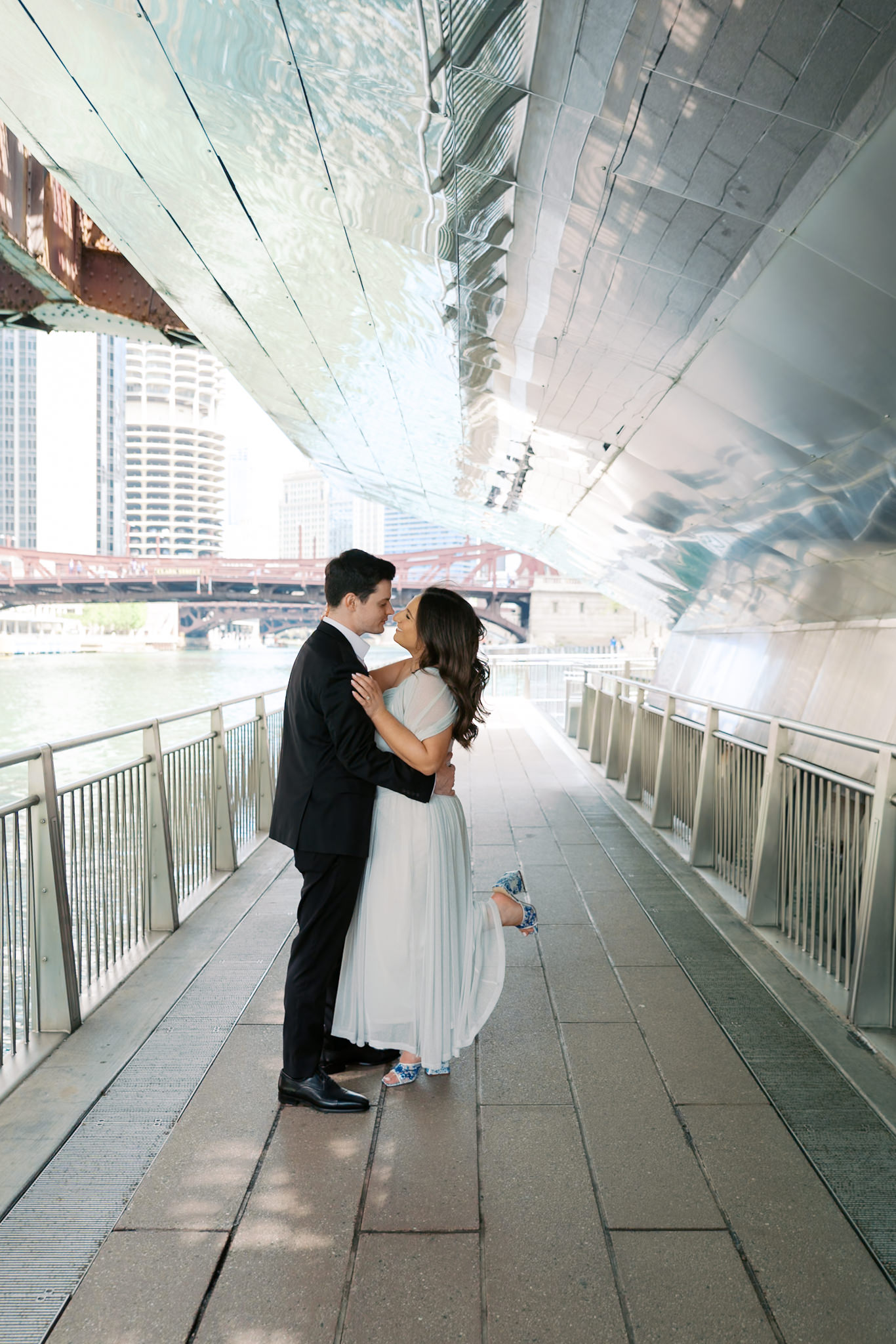 engagement picture under bridge along the Chicago riverwalk in summer