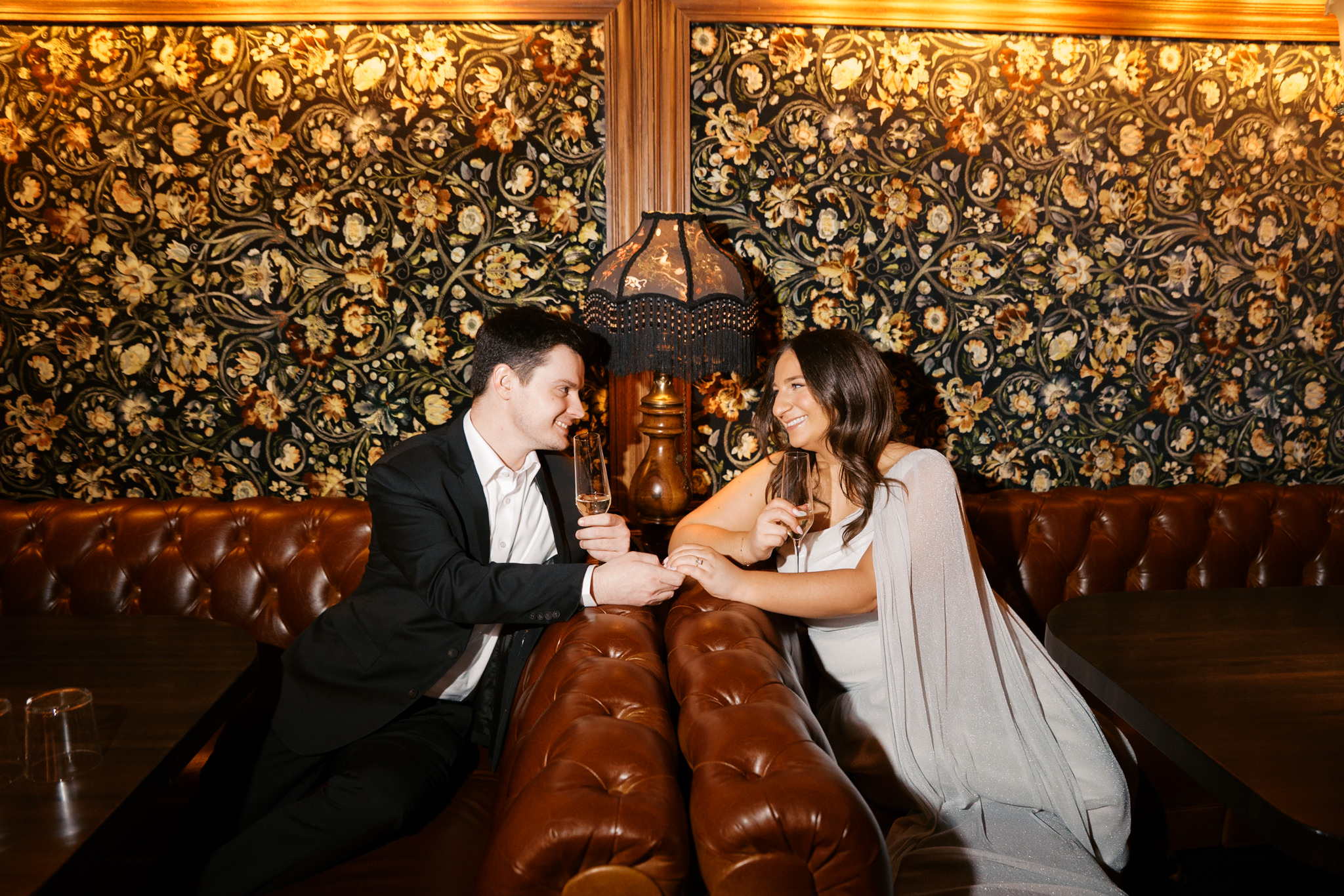 couple looking at each other at Gilt Bar engagement pictures
