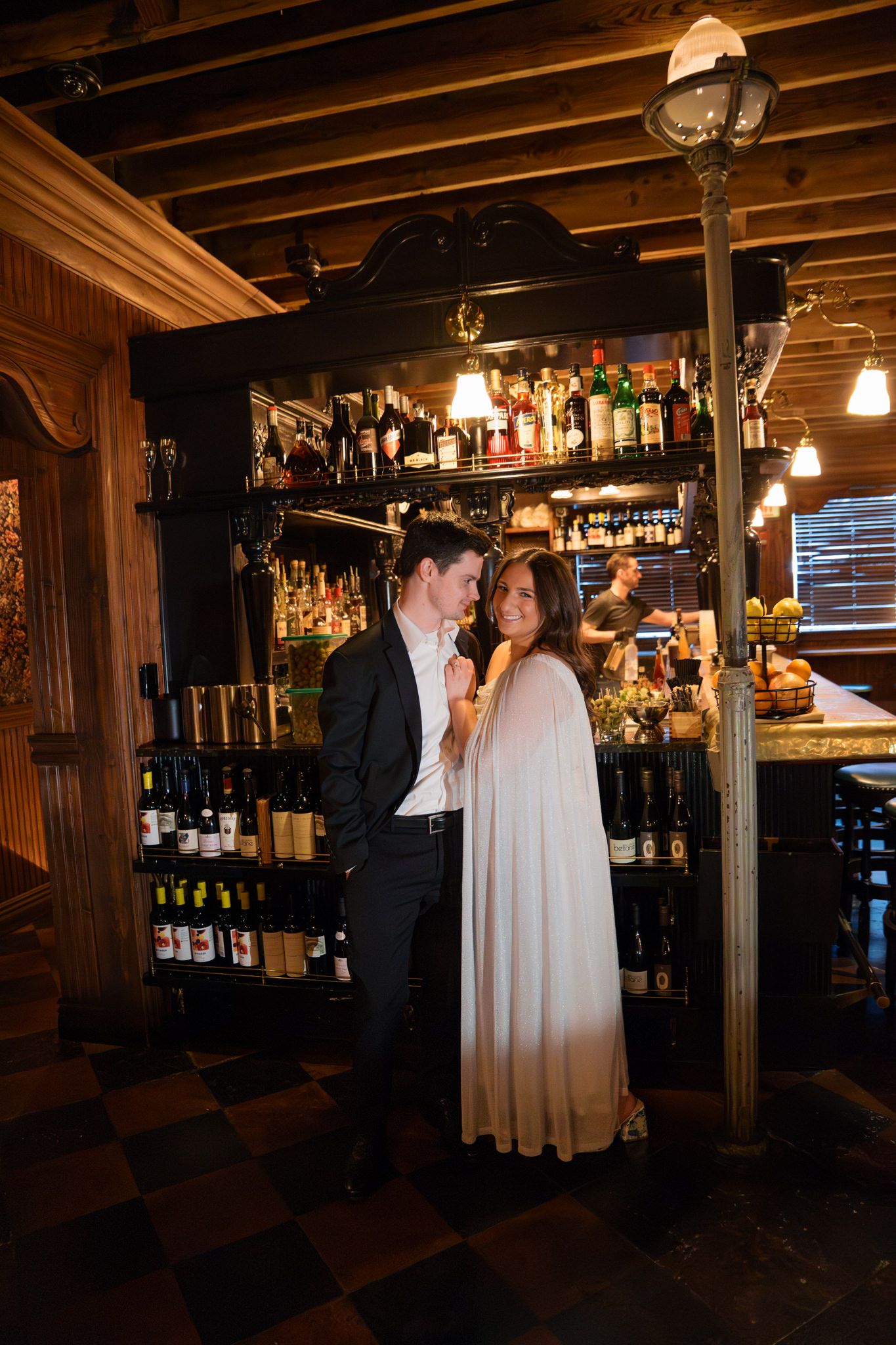 gilt bar engagement pictures with white dress and suit